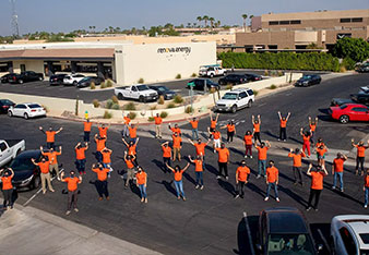 Renova Employees with hands up. Aerial photo.
