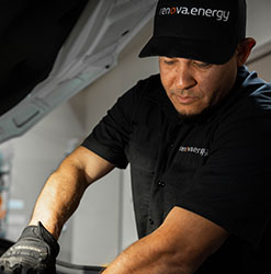 Renovian Working On A Project. Man with a black renova hat and black short sleeve renova shirt working with black gloves on