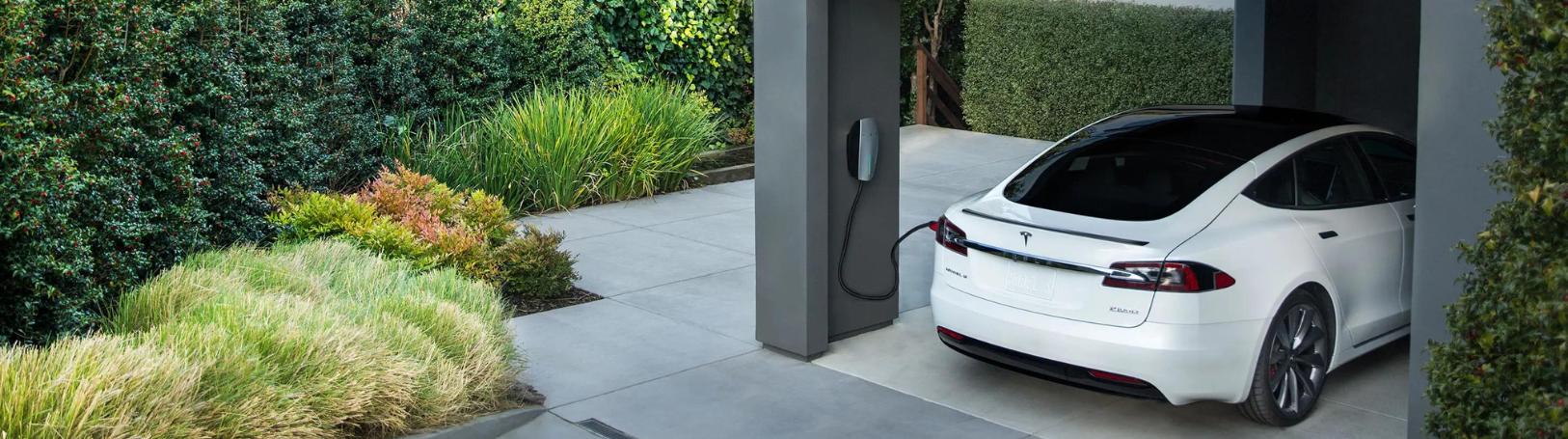 Tesla EV In Garage Being Charged With Tesla Charger