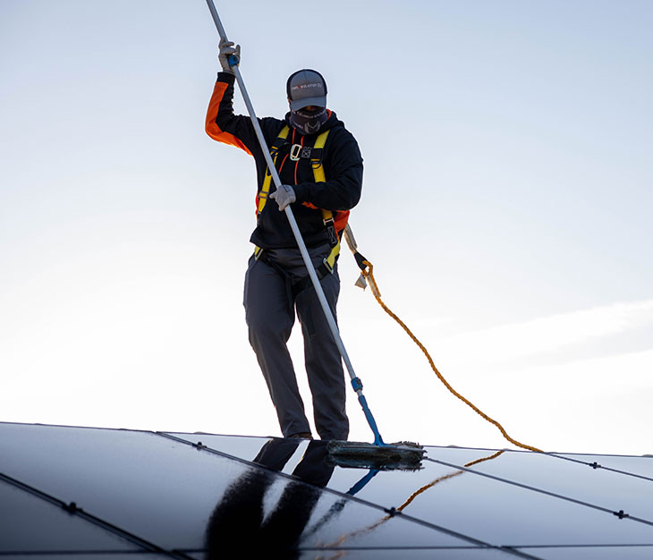 Renovian cleaning a solar panel.