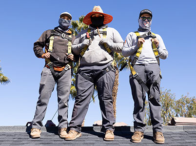 3 Renovian installers standing on the roof of a home. 