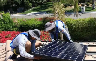 Renova installers working on a solar panel.