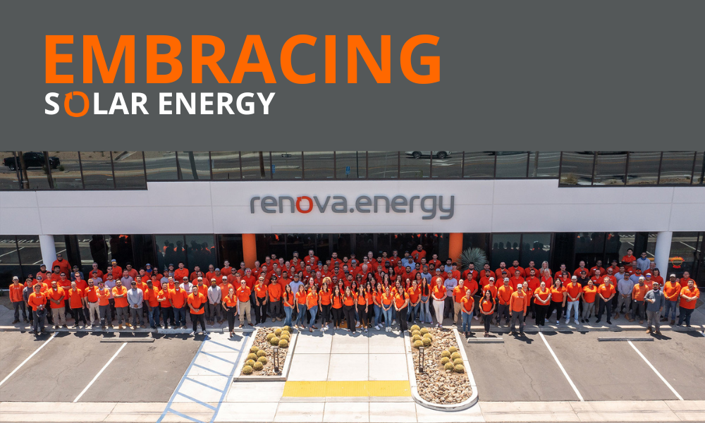 A large group of people wearing orange and red shirts stand in front of a building with the sign renova.energy. Above, bold text reads EMBRACING SOLAR ENERGY with SOLAR in orange. Desert plants and a parking lot are in the foreground.