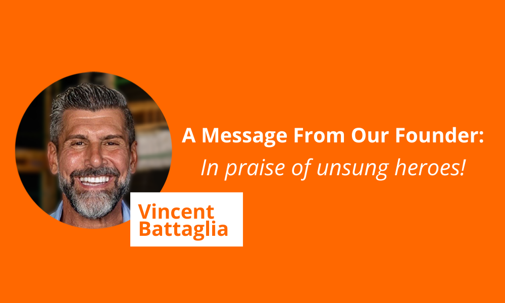 An image with an orange background features a smiling man with gray hair and a beard inside a circular frame on the left. Text reads, A Message From Our Founder: In praise of unsung heroes! with the name Vincent Battaglia in bold white text on an orange rectangle.