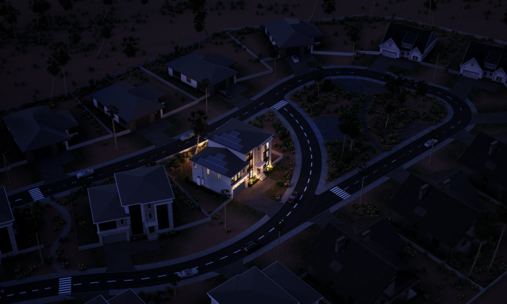 Aerial view of a quiet suburban neighborhood at night with streetlights illuminating curved roads and crosswalks. Houses are dimly lit, with one brightly lit home at the center. Trees and lawns are visible, creating a peaceful atmosphere.