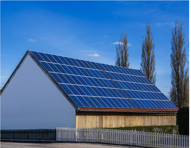 a barn with a completely covered roof of solar panels