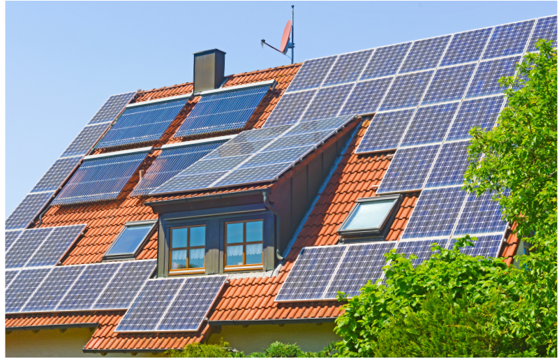 a house with a red roof and solar panels