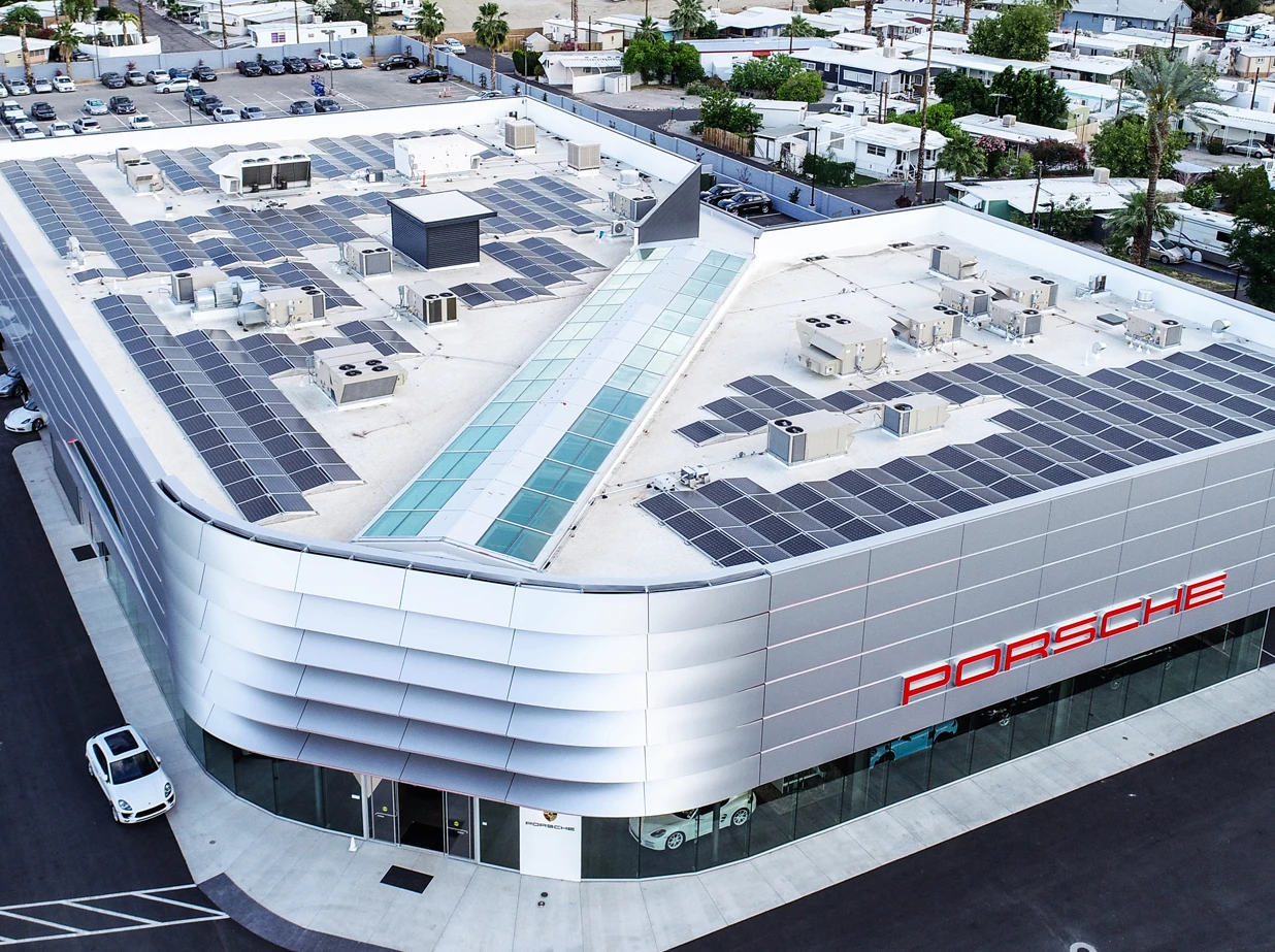 large business building with many solar panels on the roof